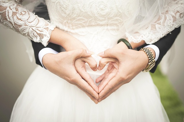 Couple forming a heart with their hands